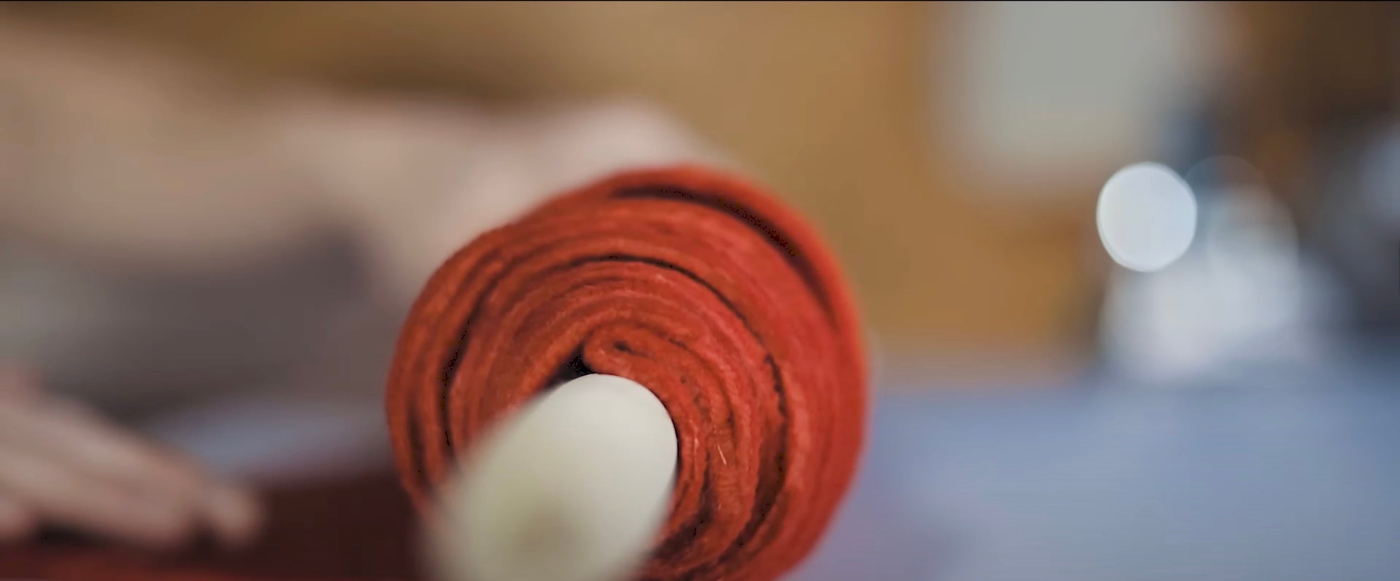 Close-up of a red yoga mat with a blurred background
