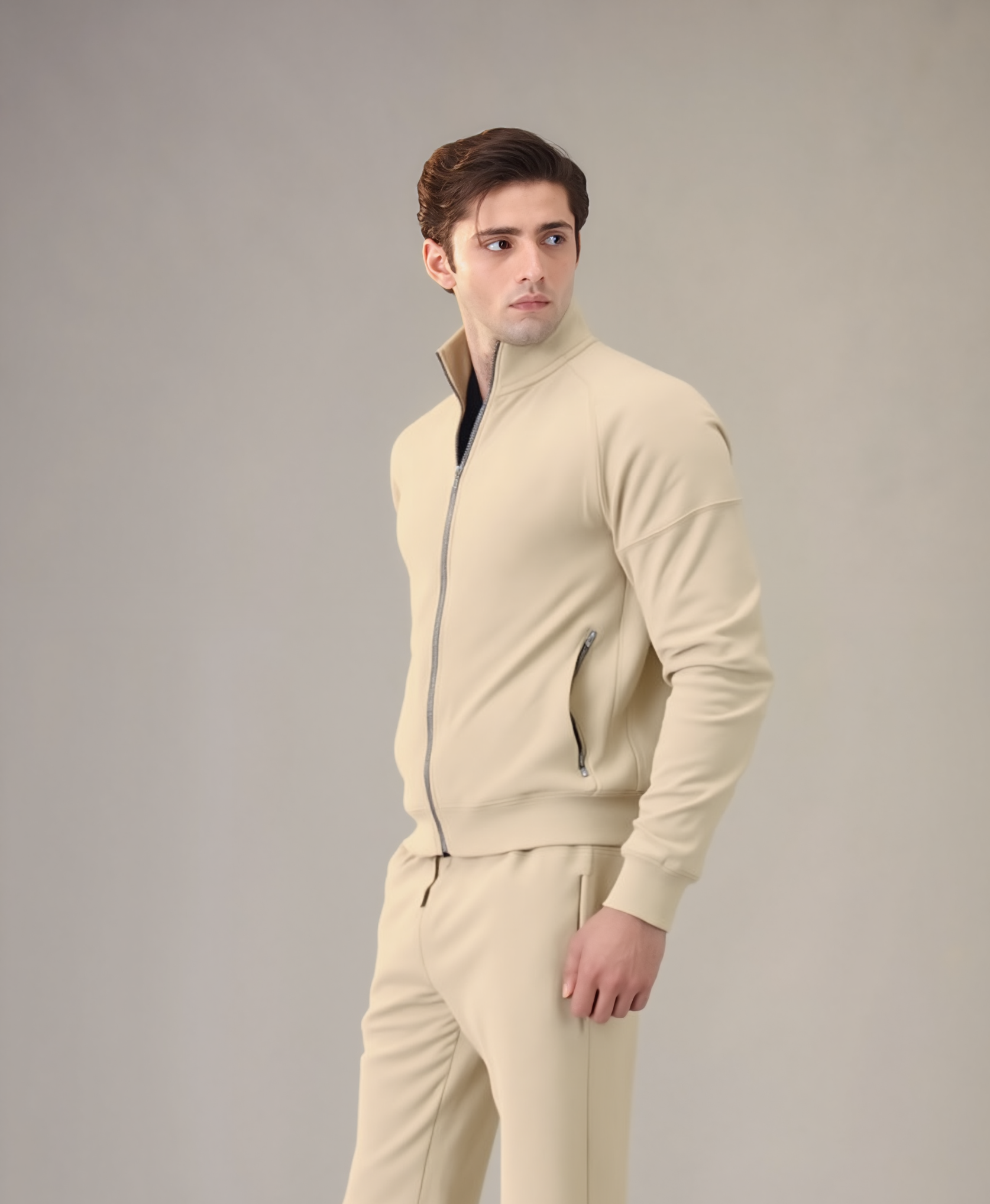 Man wearing a beige tracksuit against a plain background
