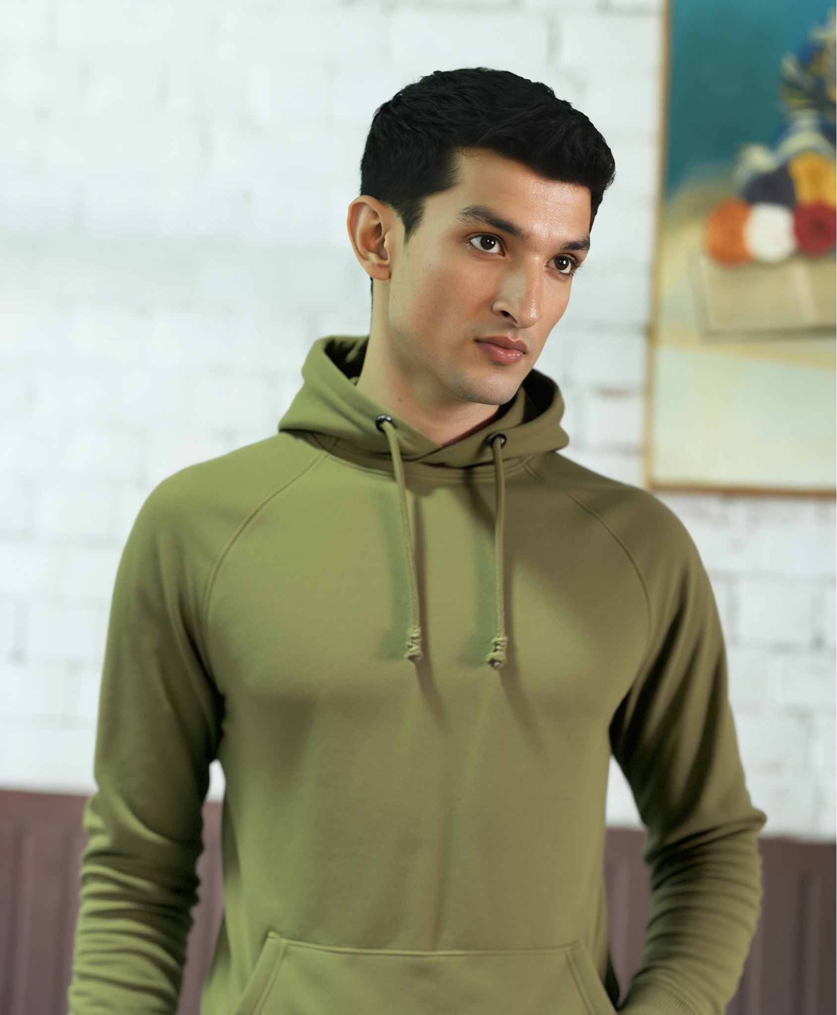 Man wearing a Black hoodie in an indoor setting with Novera Logo on Chest Point.